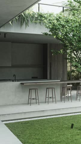 An outdoor kitchen is shown with a bar and stools. The space includes plants and an open design. It highlights a simple dining area for gatherings in a relaxed setting.
