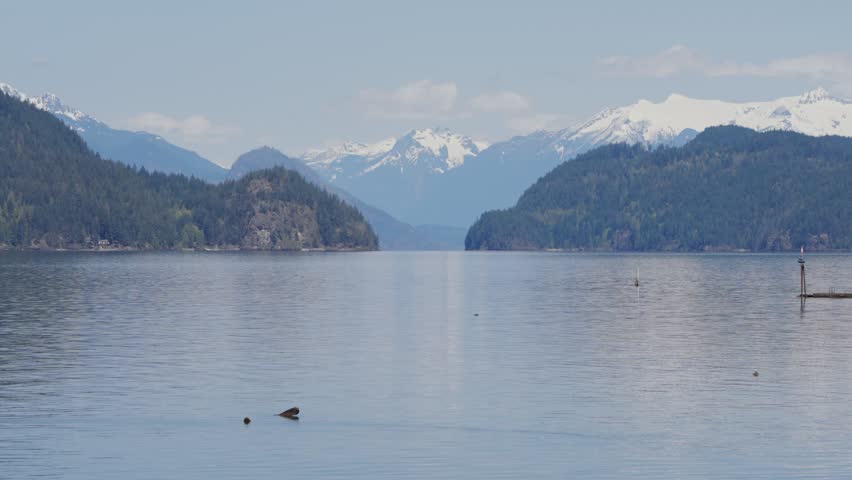Harrison Lake with snow capped mountains in the background in British Columbia, Canada