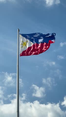 Philippine Flag Waving in Breezy Clear Sky.