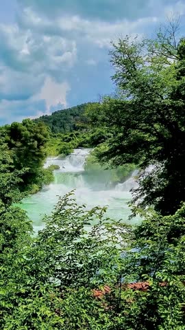 Powerful waterfalls of Krka National Park in Croatia surrounded by lush greenery. Scenic freshwater cascades showcasing pure nature, eco tourism and famous travel destination.