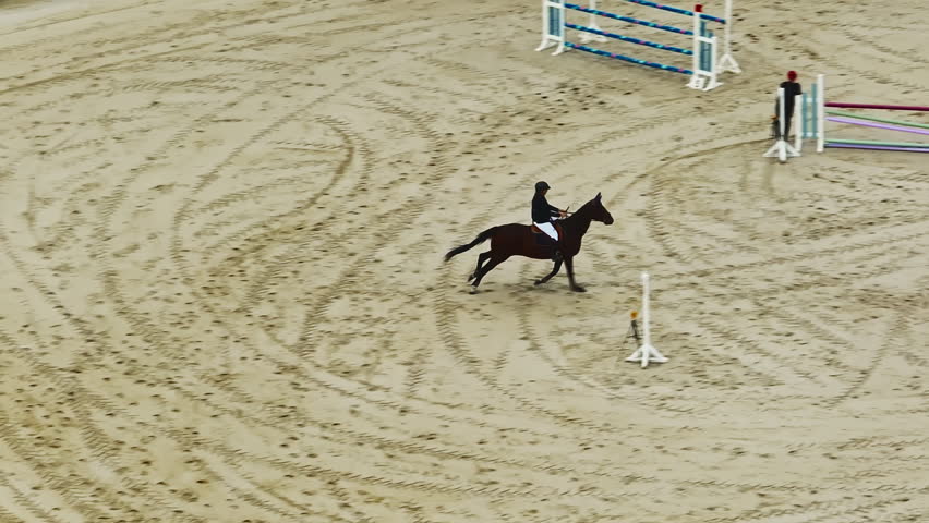Aerial view of equestrian competition outdoors jumping hurdle