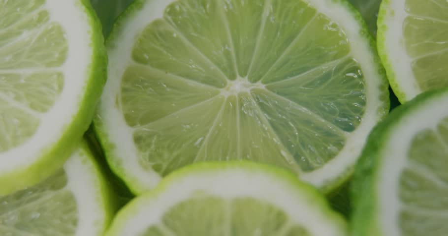 Map fading in then HUD overlays animating over lime slices, visualizing global data clusters. Macro, citrus, globe, network, hexagonal, grid, node