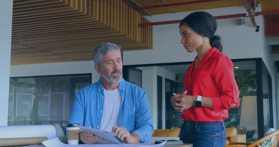 A group of executives are discussing something on a desk in an office. Global education digital interface and connections concept digitally generated video.