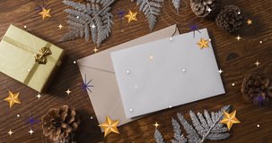 Animation of christmas decorations with cards with copy space over snowflakes on wooden background. Christmas, festivity, celebration and tradition concept digitally generated video. - Powered by Shutterstock - Get 15% off with code: PIKWIZARD15