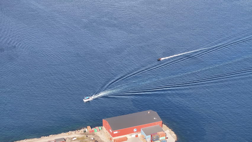 Aerial view of the speed boats on arctic ocean in Tasiilaq town, Greenland