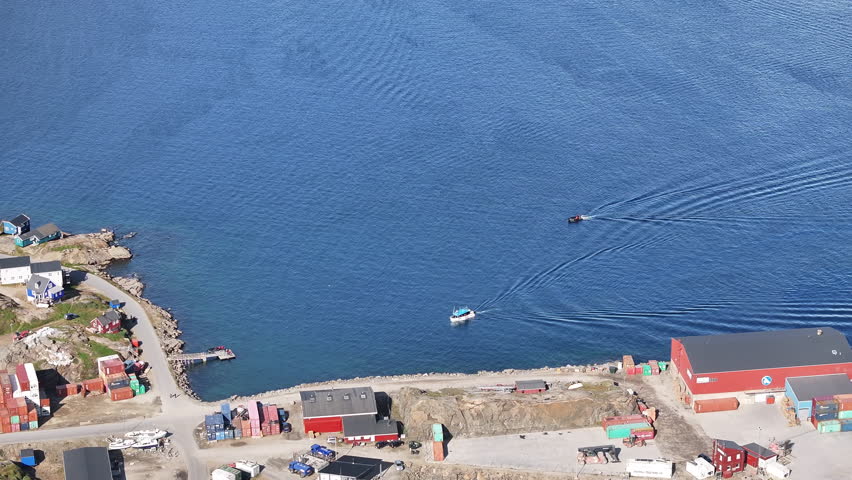 aerial view of the sailing boat on arctic ocean in Tasiilaq town of the Greenland
