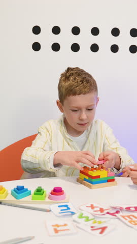 Child psychologist helping a young boy with educational toys