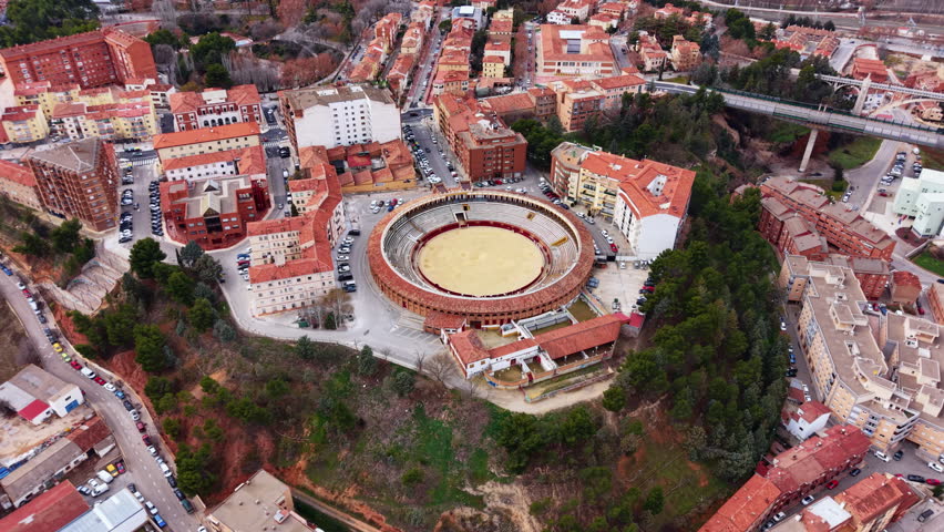 View of the historic bullring in Teruel city, showing the circular corrida stadium integrated into the dense urban fabric of Aragon, Spain