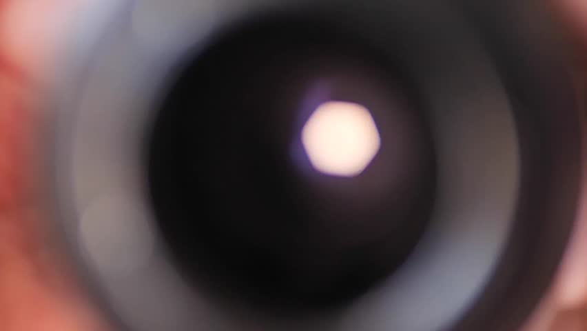 Camera lens 6-blade iris aperture closing during a pull-back shot
