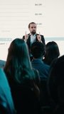 Vertical Video Inspirational business presentation at international summit with diverse mixed age audience, networking event in conference hall. Male CEO presenter speaks to listeners about - Powered by Shutterstock - Get 15% off with code: PIKWIZARD15
