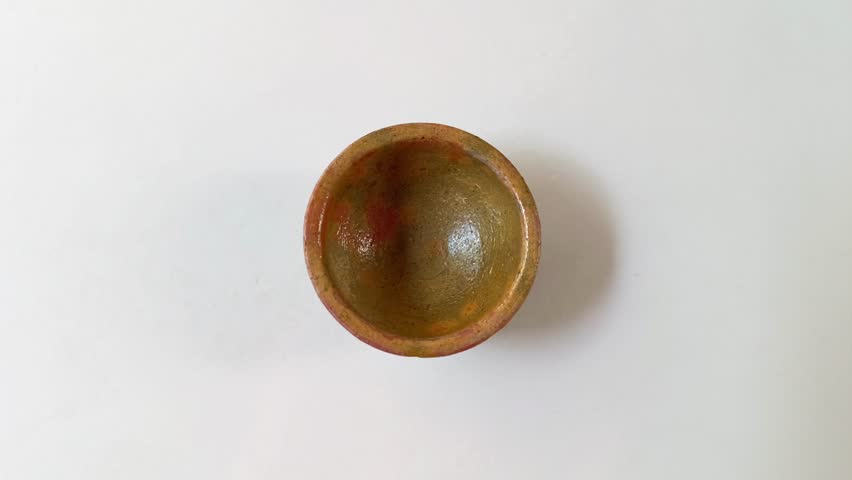 Top view of a handmade clay bowl crafted in Guatemala, isolated on a white background, highlighting artisanal pottery texture, rustic character, and simple traditional design.