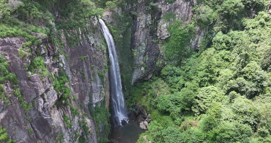 Close-up overhead drone footage of Jade Curtain Waterfall (Yu Lian Spring) in Lushan Mountain, Jiangxi Province, China.