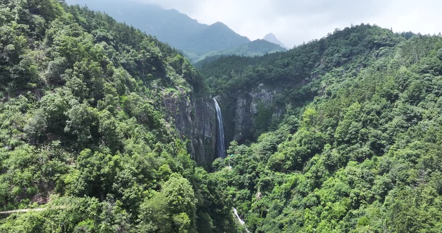 Aerial drone footage of Jade Curtain Waterfall (Yu Lian Spring) cascading from southern slope in Lushan Mountain, Jiangxi Province, China.