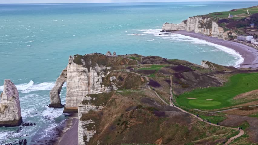 Aerial establishing of dramatic white chalk cliffs and turquoise sea along the Normandy coastline in France