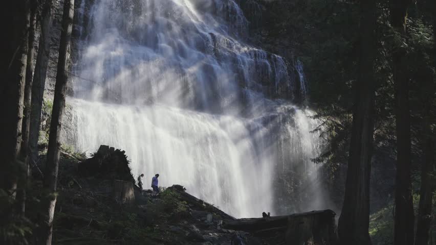 Bridal Veil Falls in British Columbia forest with hikers enjoying nature in Canada