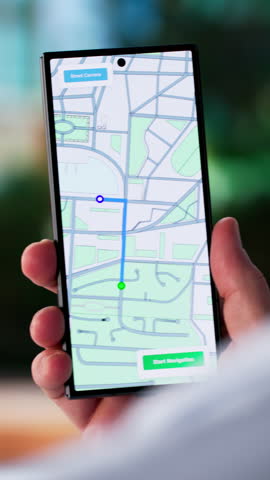 Traveling Businessman Navigating City Streets With GPS On His Phone. Tourist Exploring Urban Area With Electronic Map