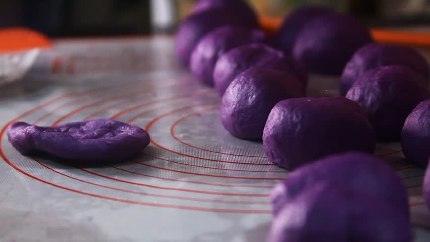 Filipino food called Ube Cheese Pandesal being prepared for baking.