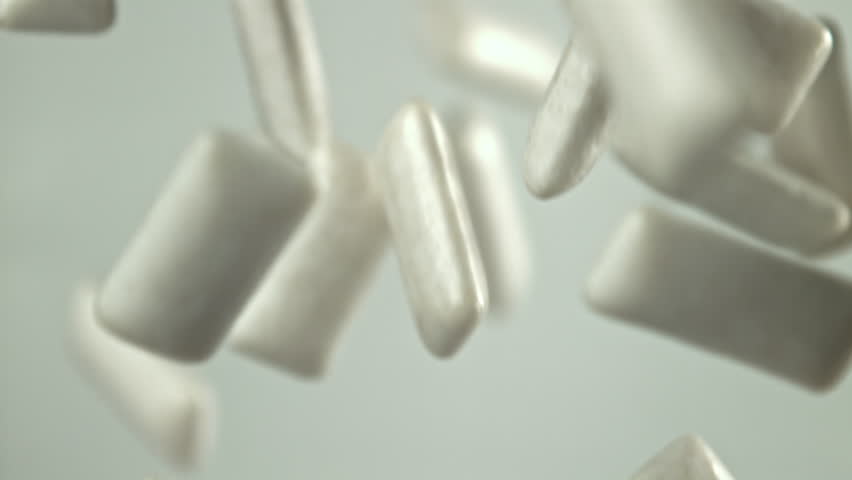 Chewing gum flies on a white background. Filmed on a high-speed camera at 1000 fps. High quality FullHD footage
