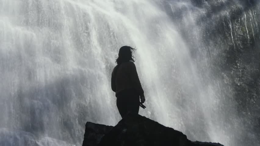 Woman silhouette standing before Bridal Veil Falls in British Columbia, Canada