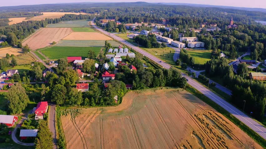 Aerial View of Scenic Rural Landscape with Fields, Houses, and Roads in a Peaceful Community in Finland
