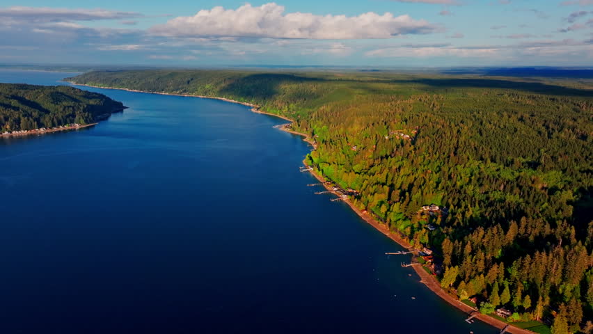 drone aerial of a serene lake in Olympic National Park, Washington. Calm water, dense forest and mountain scenery create a peaceful wilderness landscape in the Pacific Northwest.