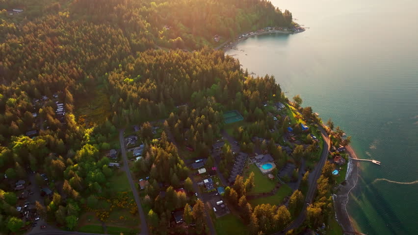 drone aerial of a serene lake in Olympic National Park, Washington. Calm water, dense forest and mountain scenery create a peaceful wilderness landscape in the Pacific Northwest.