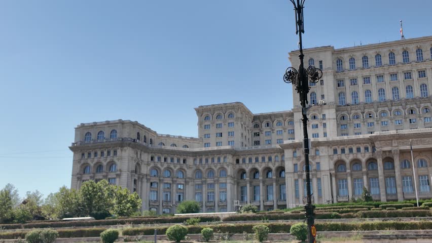 Pan across the exterior of the Palace of Parliament in Bucharest, showcasing its massive scale and architecture.