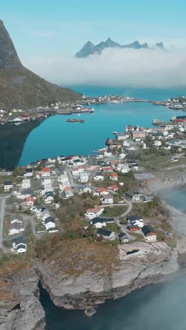 Stunning drone footage of the picturesque fishing village of Reine surrounded by mountains and sea