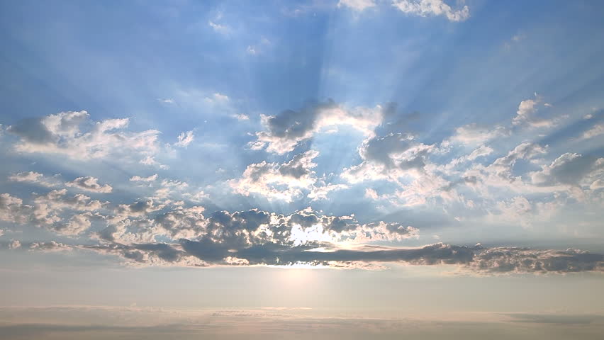 Beautiful landscape. Sky scenery. Calm blue sky, white clouds and sun rays shining through clouds. Sunny morning with sunny beams on sky. Natural background