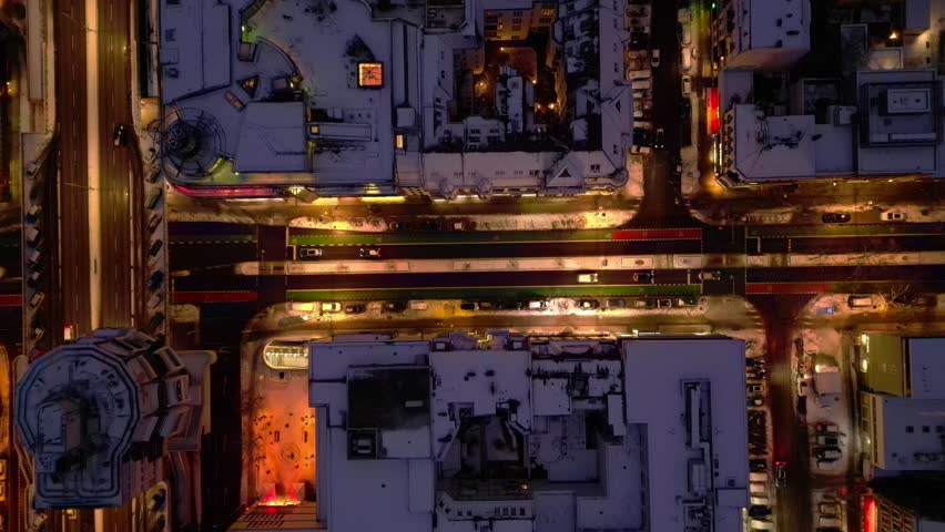 Berlin illuminating shopping street snowed at night. Unique aerial view drone