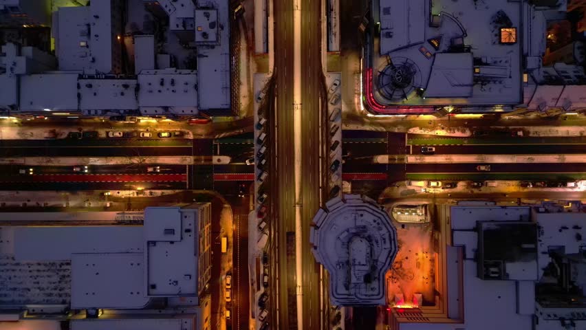 Berlin illuminating shopping street snowed at night. Perfect aerial view drone