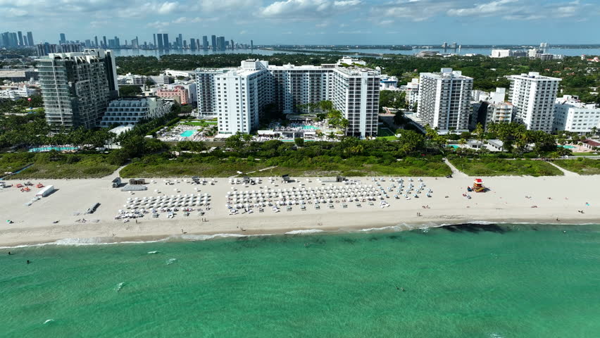 An aerial perspective highlights 1 Hotel Miami Beach stretching along the shoreline with rooftop pools and ocean views.