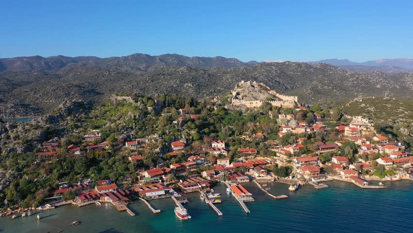 Aerial view of the picturesque secluded village of Kaleköy (Simena) on the Lycian coast of Turkey (Antalya region), famous for its partially submerged ancient ruins.