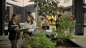 Young business professionals are seen working remotely and collaborating outdoors. They engage in discussions, reviewing documents and strategizing in a dynamic, modern office environment. - Powered by Shutterstock - Get 15% off with code: PIKWIZARD15