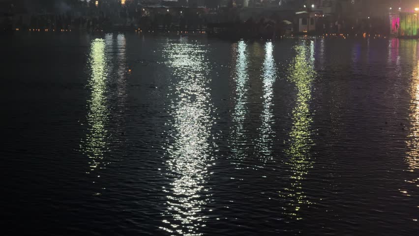 Night view reflects light into rippled water. Use this serene shot in many projects
