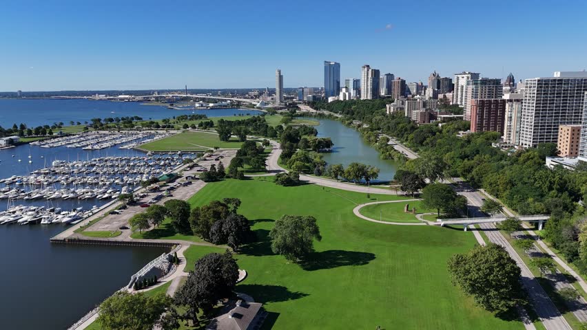 Aerial of Downtown Milwaukee Wisconsin on Labor Day Weekend.  Drone approach shot of boats and marina with skyline in the background.