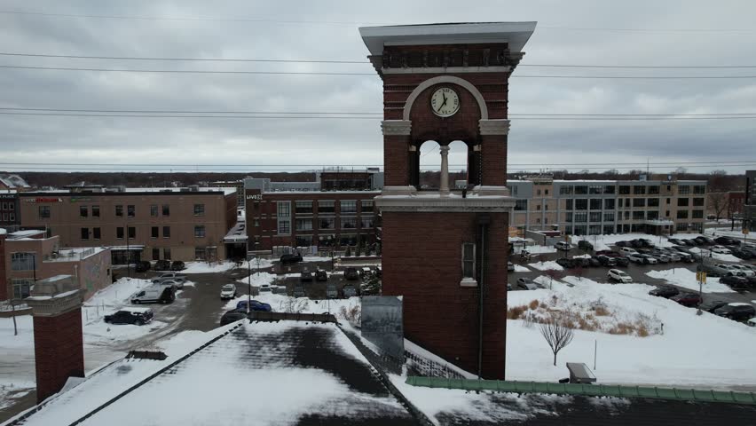 Drone shot of Green Bay Wisconsin Downtown after snowfall in the winter.  Aerial orbital shot of clock tower.