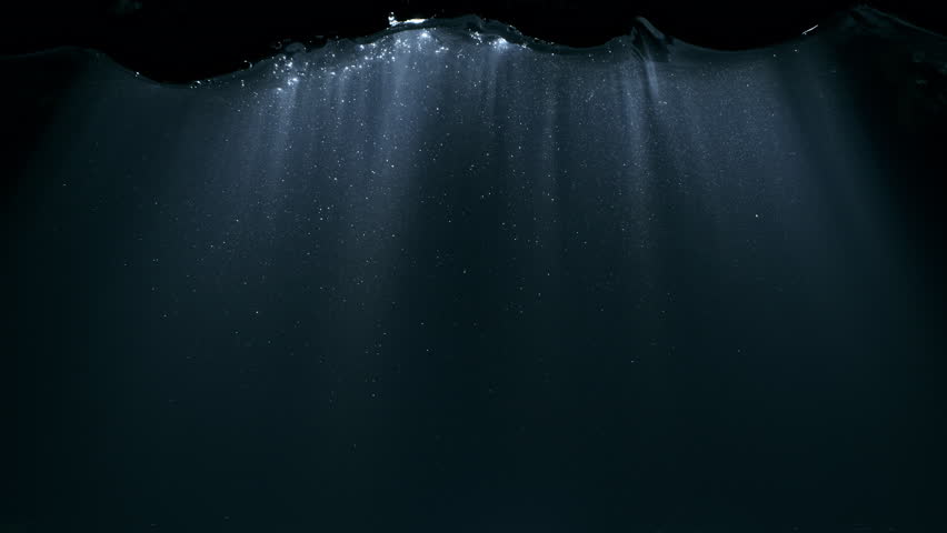 Super Slow Motion of Underwater Sun Rays Shimmering Through Dark Water at 1000fps.