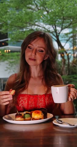 Stylish woman savoring a delicious pastry and hot coffee in a chic cafe, perfect for luxury lifestyle, relaxation, and sweet indulgence concepts.