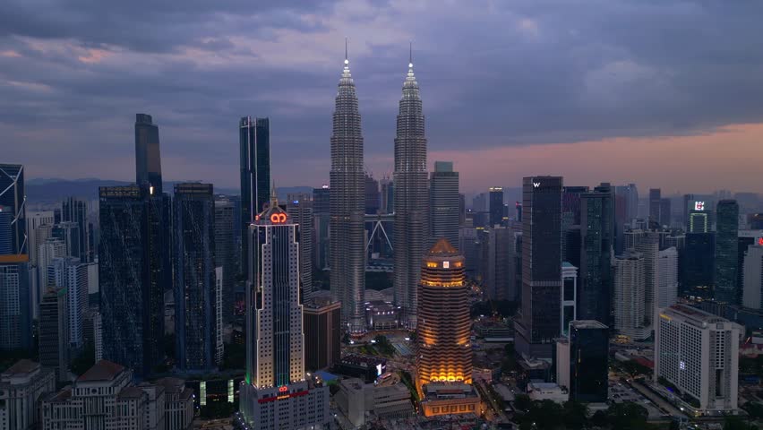 Petronas Twin Towers Kuala Lumpur at night. Dramatic aerial view drone