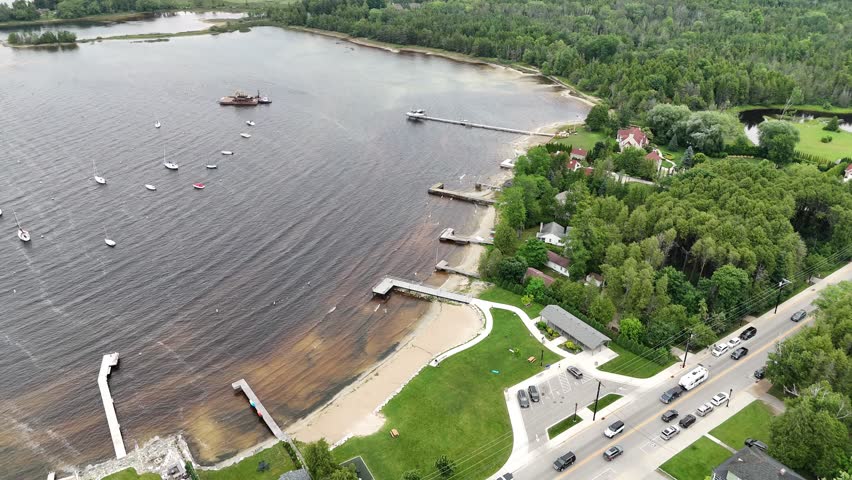 Aerial of Fish Creek in Door County Wisconsin on an overcast day.  Nosedive drone shot of docks and boats on the shoreline.