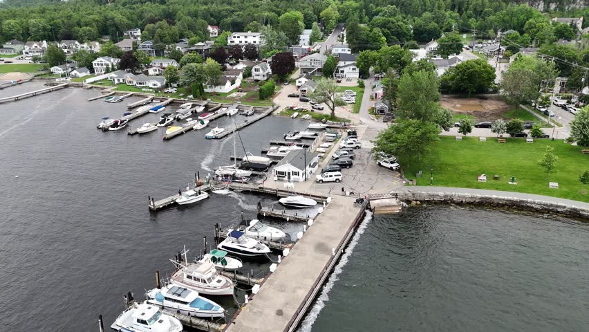 Aerial of Fish Creek in Door County Wisconsin on an overcast day. Drone push shot over harbor and boats.