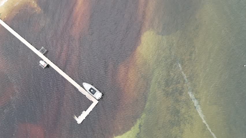 Aerial of Fish Creek in Door County Wisconsin on an overcast day.  Birdseye Drone shot of shoreline.