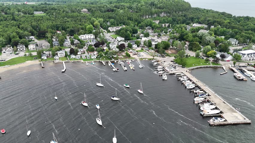 Aerial of Fish Creek in Door County Wisconsin on an overcast day. Orbital over marina an townscape by drone.