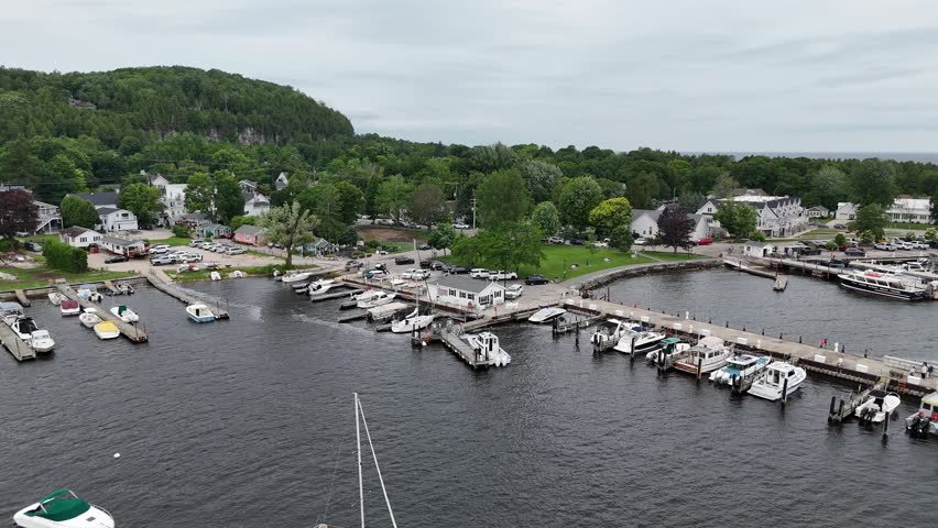 Aerial of Fish Creek in Door County Wisconsin on an overcast day. Orbital of Bluff and marina below.