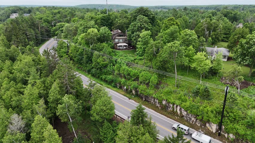 Aerial of Fish Creek in Door County Wisconsin on an overcast day.  Pull shot showing homes and bluff side of harbor.