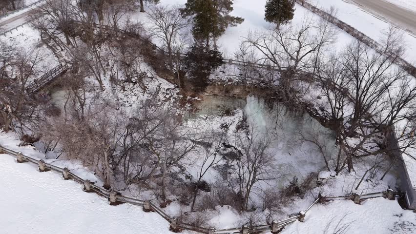 High Drone Orbital shot of Frozen Waterfall in Green Bay Wisconsin.