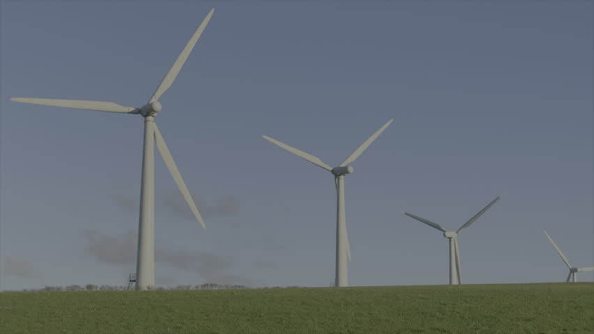 Wind turbines in a field with blue skies and green grass renewable energy and green electricity UK 4K