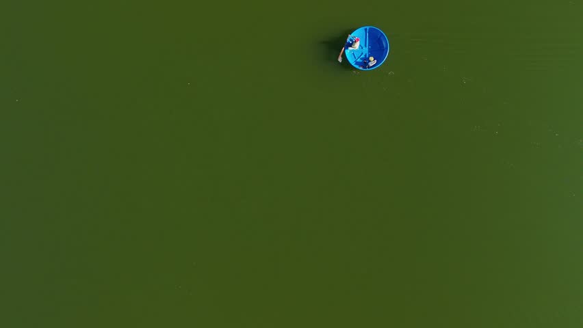 Cinematic aerial drone flight over the lush tea plantations of Munnar, Kerala, India, revealing winding roads disappearing into soft morning mist and serene lakes far below. The layered green hills and drifting fog create a tranquil atmosphere, capturing the beauty of South India’s highland landscape at sunrise. אידeal for themes of travel, eco tourism, nature, agriculture, serenity, and scenic destinations.