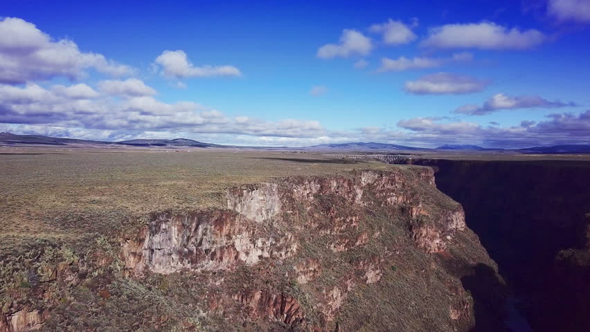 Rio Grande Gorge with blue sky and clouds, River in Canyon, Desert Mesa, American Southwest Landscape, Taos New Mexico, 4K Drone Aerial